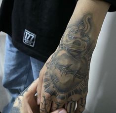 a man with a tattoo on his arm and hand