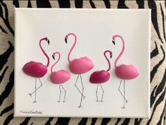 three pink flamingos are standing next to each other on a zebra - print background