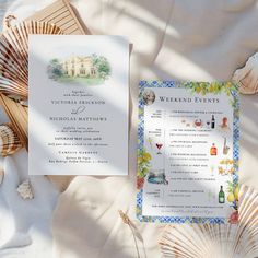 the wedding stationery is laid out with shells and seashells