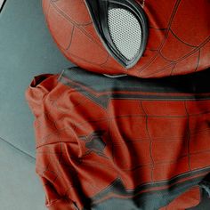 a close up of a person wearing a spider man costume