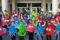 a group of children in costumes posing for a photo