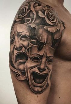 a man's arm with some tattoos on it, including two masks and roses