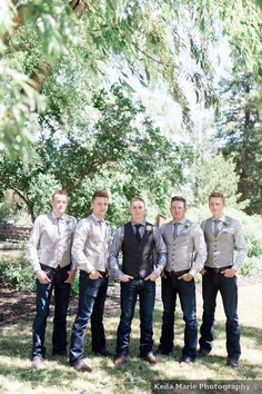 a group of young men standing next to each other on top of a grass covered field