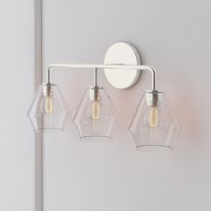 three light fixtures mounted on a white wall