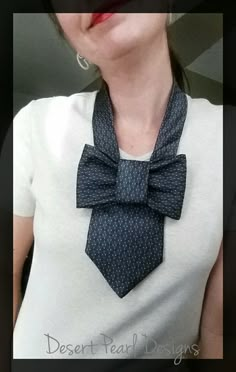 a woman wearing a white t - shirt and a blue tie with polka dots on it