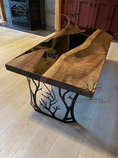 a table made out of wood and metal with an artistic design on it's top