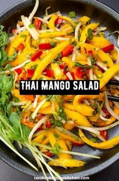 thai mango salad in a skillet with the words, thai mango salad