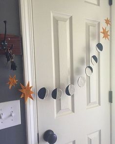 a door decorated with stars and moon garlands on the front door to a house