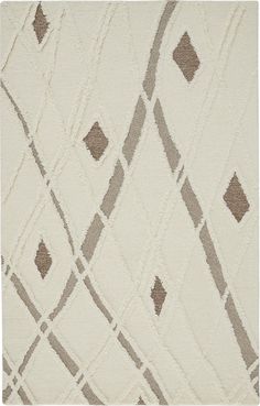 a white rug with brown and gray squares on it's sides, in the shape of an abstract design