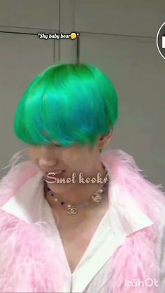 a woman with green hair and pink fur coat