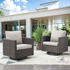 two wicker chairs sitting on top of a tiled floor next to a patio area