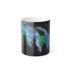 a black and white coffee mug with an aurora bore in the sky