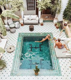 an aerial view of a pool with people in it