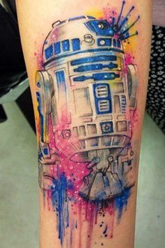 a watercolor tattoo on the leg of a person with a star wars r2d2