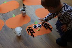 a toddler playing with halloween decorations on the floor