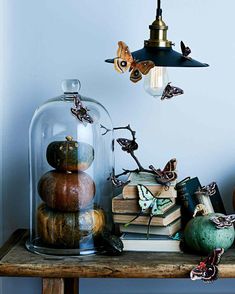 a table topped with lots of books under a clochet covered in glass dome