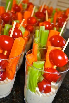 small cups filled with fruit and veggies on skewered toothpicks