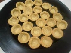 a pan filled with mini pies sitting on top of a stove