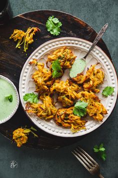 the best ever air fryer onion bhaji recipe on a white plate with cilantro garnish