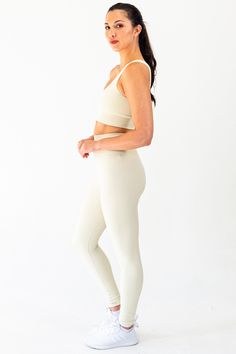 The Contrast Legging in Cream embodies a union of function and aesthetic. Crafted from moisture-wicking, 4-way stretch power fabric, the garment is lightweight, breathable, and functional. The minimal design is discreetly elevated through the inclusion of ribbing detail down the side of the legs as well as around the glutes. Branding details include an inconspicuous SLAIT logo in reflective detail located on the back of the waistband. Material: 87% Nylon & 13% Spandex GSM: 280G Model is 5'8" and wears a size M Beige Stretch Yoga Pants, Versatile Solid Activewear With Minimal Stretch, Beige Stretch Yoga Pants, Sporty Style, Sporty Stretch Beige Yoga Pants, Beige Stretch Sporty Yoga Pants, Sporty Beige Yoga Leggings, Sporty Beige Stretch Yoga Pants, Seamless 4-way Stretch Leggings For Light Exercise, Seamless Leggings With 4-way Stretch For Light Exercise