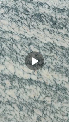 an aerial view of a marble surface with a circular hole in the middle