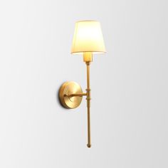 a wall light with a white shade on it's side and a gold arm