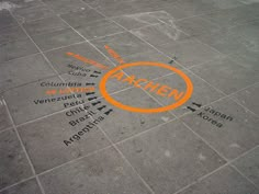 an orange circle is drawn on the ground with words written all over it in different languages