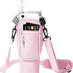 a pink cell phone holder with money in it and a camera strap attached to it