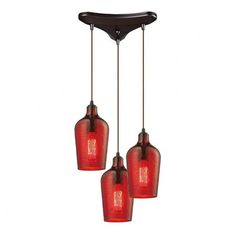 three red glass pendant lights hanging from a ceiling