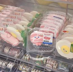 plastic containers filled with different types of food in a display case at a grocery store