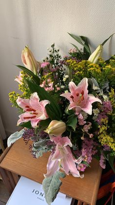 a bouquet of flowers sitting on top of a wooden table