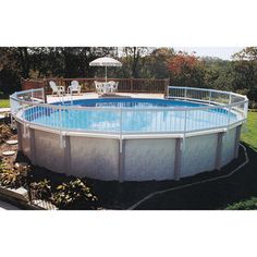 an above ground swimming pool surrounded by grass