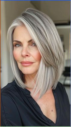 Transitioning to gray hair can present challenges. The interim period of growing out your natural color can feel uncomfortable and awkward. Finding a suitable hairstyle to navigate this phase is essential in seamlessly bridging the gap until all your hair has fully transitioned. Embrace this process by experimenting with different styles that make you feel confident and empowered during this unique stage of transformation. Med Gray Hairstyles, Transition To Grey Hair With Highlights, Grey Hair Growing Out Transition, Gray Lob Haircut, Blonde To Grey Hair, Blonde To Grey Transition, Growing Out Gray Hair Blending, Women With Gray Hair, Transitioning To Gray Hair