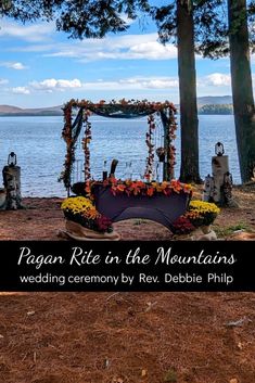 a wedding ceremony by the water with flowers and decorations on display in front of it