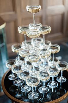 a table topped with lots of wine glasses