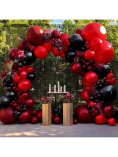 a large red and black balloon arch