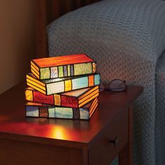 a stained glass lamp sitting on top of a wooden table