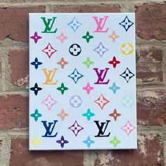 a white square with multicolored louis vuitton stickers on it