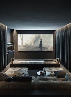 a living room with two couches and a large screen