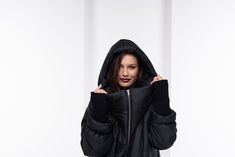 "This oversize winter jacket has elastic fabric on the sleeves. This is an extravagant model with a large hood, side pockets, long front zipper, and high collar when zipped. This urban-style jacket has a street vibe and will keep you warm for sure. * Please have in mind the model is oversize - for a fitted look please go a size down. Review from our customer: \"This coat is amazing! As soon as I put it on and stepped outside, I received so many compliments. Everyone said I looked so cozy...lol, My hubby thought it was way more expensive than I paid. Great quality, construction, and fast shipping!\" The model in the picture is 168cm. ⅼ 5.5 ft. tall and is wearing size S / Color: Black 🌟 INFO: * Worldwide EXPRESS shipping - please provide a phone number for shipping documents * US Sizing XS Steampunk Outfits Women, Oversized Hooded Coat, Black Cotton Jacket, Coat Waterproof, Black Quilted Jacket, Streetwear Jackets, Jacket Puffer, Black Winter Coat, Windproof Jacket