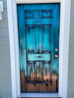 the front door is painted blue and brown