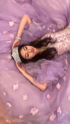 a woman in a purple dress laying on the floor