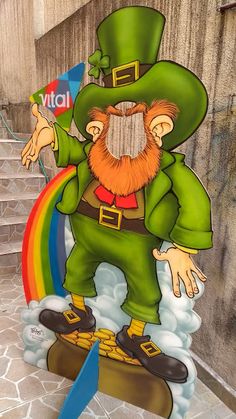 a st patrick's day sign with a lepreite standing on top of a rainbow