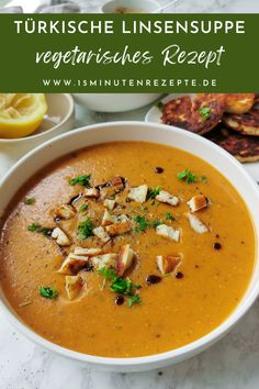 a white bowl filled with soup and garnished with parsley on the side