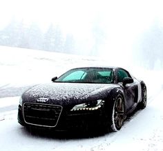 a black sports car is covered in snow