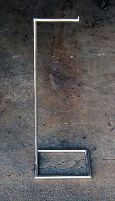 a metal object sitting on top of a cement floor