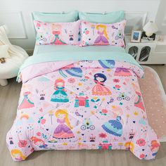 a bed covered in pink and blue comforters with princess themed designs on the sheets