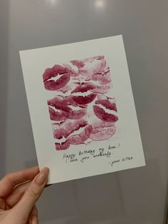 a person holding up a card with lipstick on it that says happy birthday to you