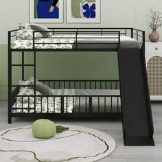 a black bunk bed sitting in a bedroom next to a white rug and green walls