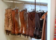 the boots are lined up and hanging on the rack in front of the door,